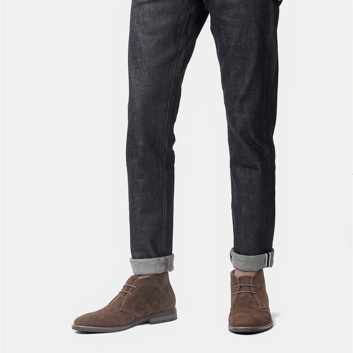 Close-up of men's brown chukka boots, showcasing quality leather and stitching.