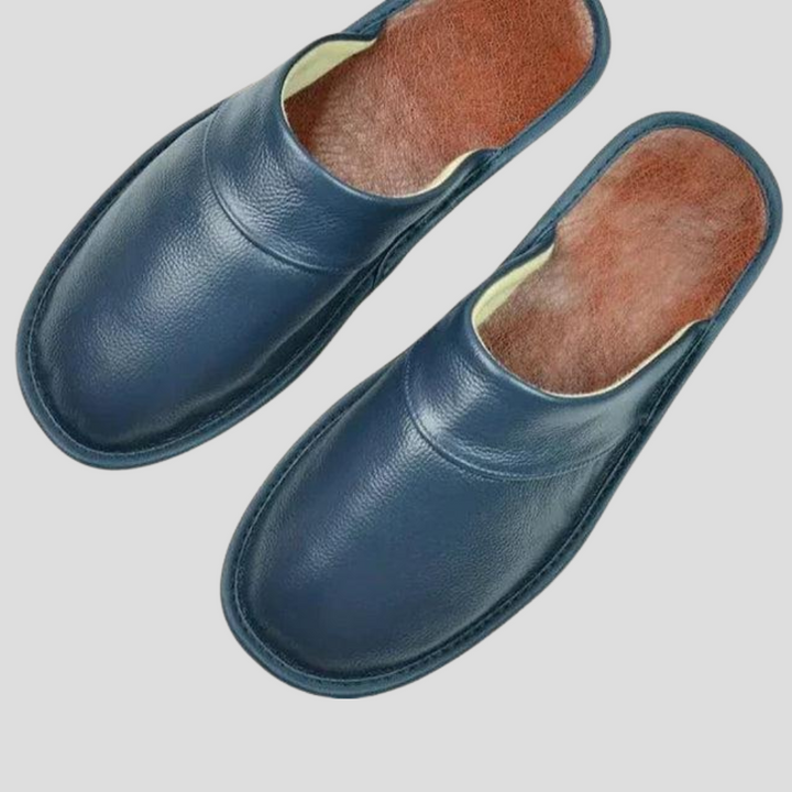 Man wearing black leather slip-on house shoes, perfect indoor footwear.