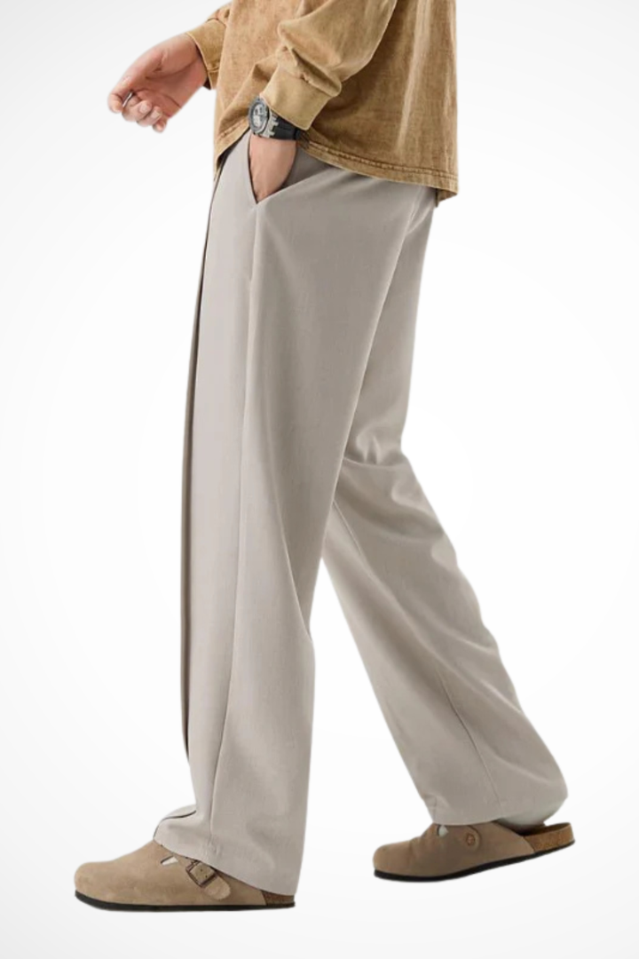 Brown pleated trousers offering a classic wide leg silhouette