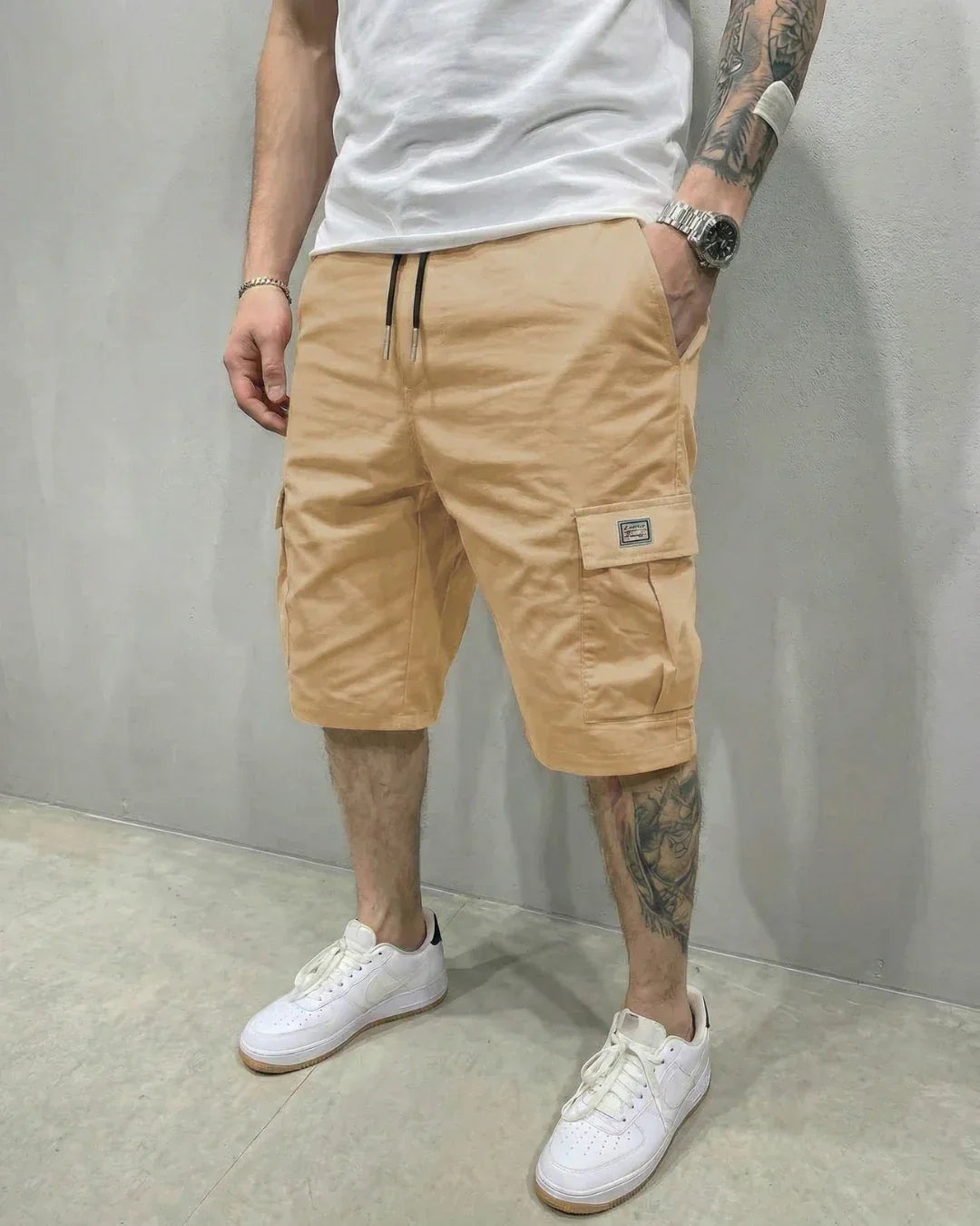 Relaxed fit men's cargo shorts, featuring a drawstring waist and multiple flap pockets, ideal for summer.