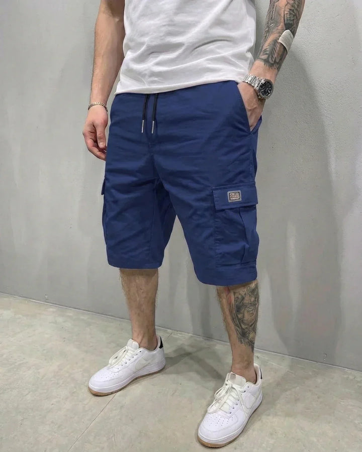 Stylish men's utility cargo shorts with a comfortable drawstring waist and functional flap pockets for casual style.