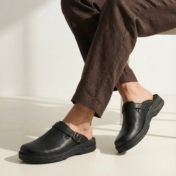 Comfortable men's leather clog slippers featuring an adjustable buckle strap