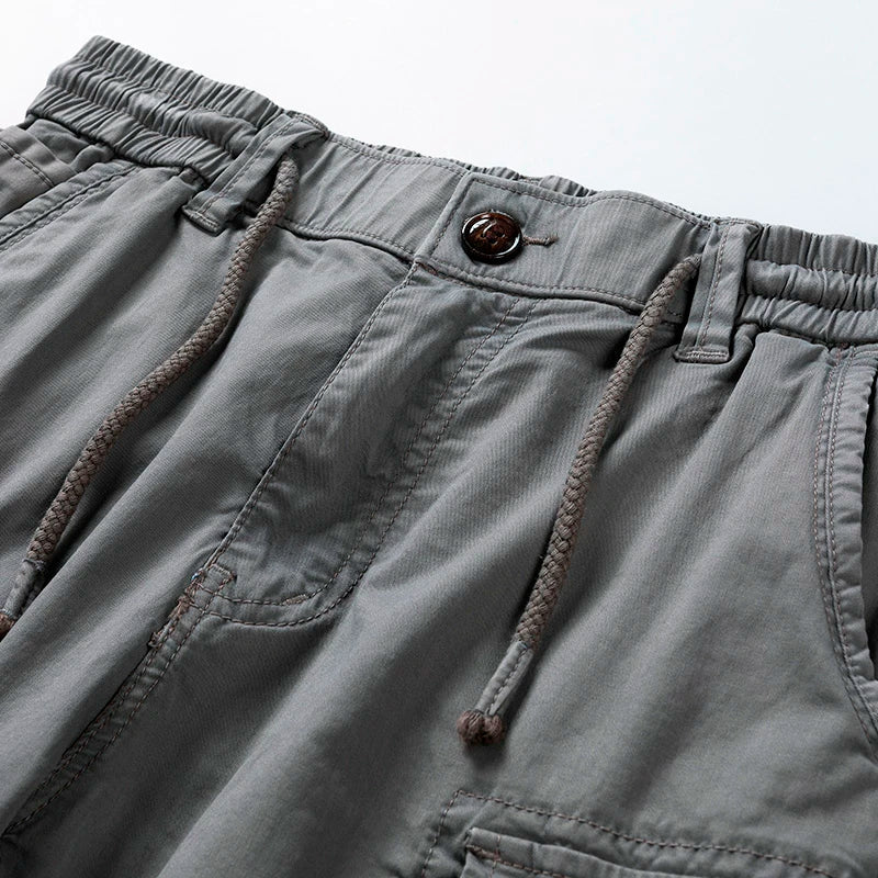 Versatile men's utility cargo shorts with drawstring waist, offering relaxed fit and practical pockets for daily wear.