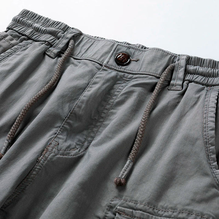 Versatile men's utility cargo shorts with drawstring waist, offering relaxed fit and practical pockets for daily wear.