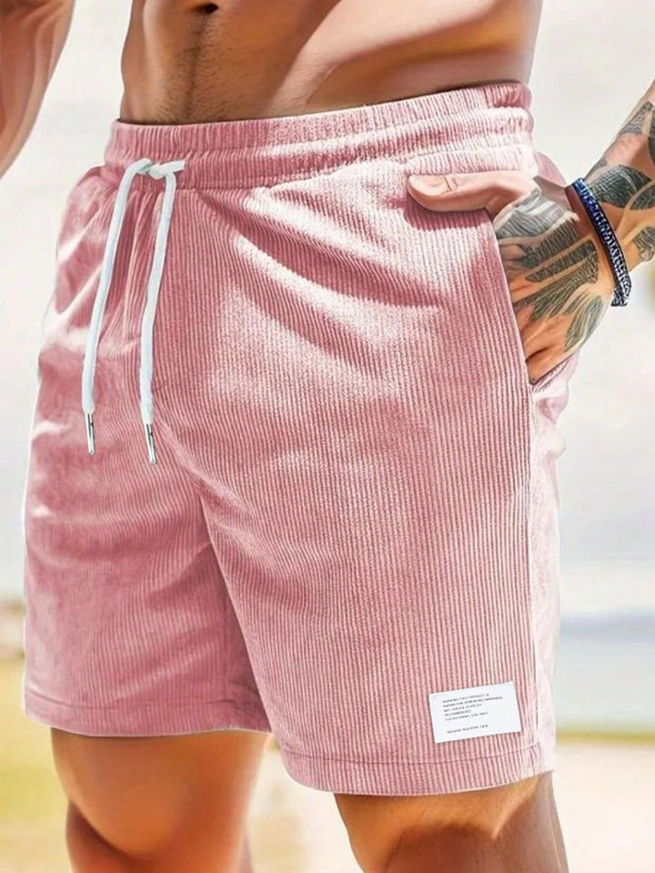 Modern men's mid-thigh ribbed casual shorts with adjustable drawstring for a comfortable, stylish summer fit.