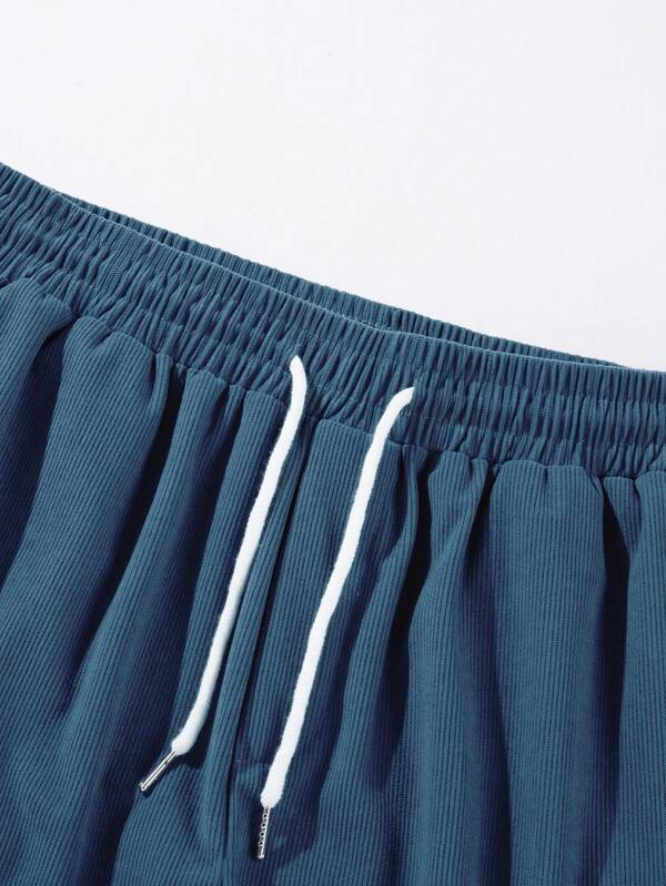 Stylish men's mid-thigh ribbed shorts with drawstring, great for summer activities, beach, or active wear.