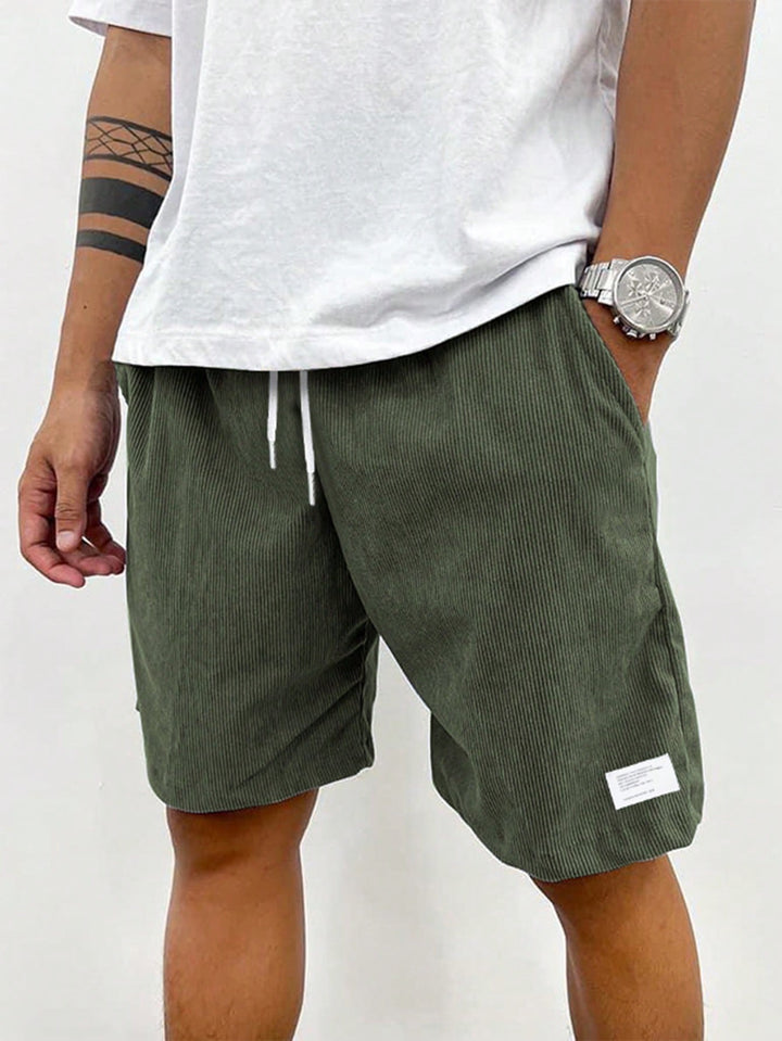 Folded men's ribbed casual shorts with drawstring. Highlights soft texture, ready for summer comfort.