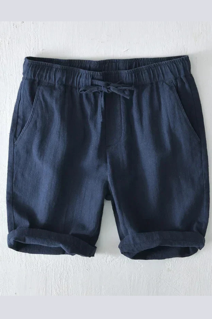 Model wearing men's casual drawstring shorts with side pockets for a summer look