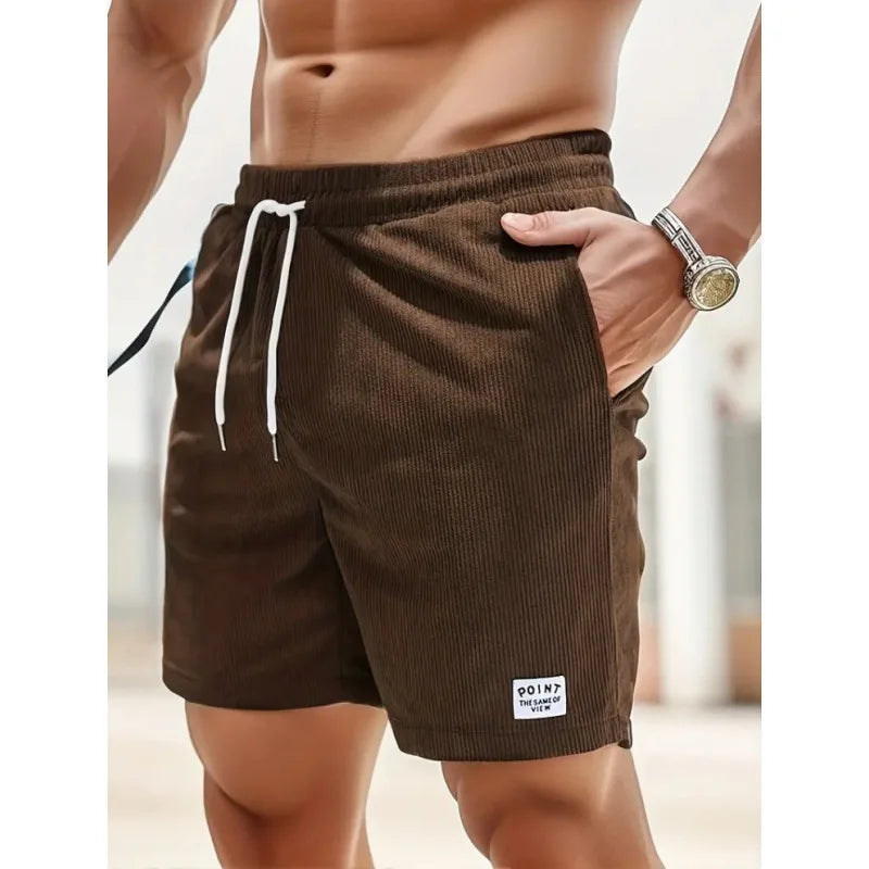 Man wearing versatile casual drawstring shorts, enjoying summer activities in comfort & relaxed fashion.