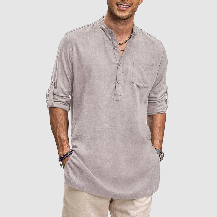 Breathable men's henley shirt, long sleeves rolled up, showcasing the chest pocket detail.