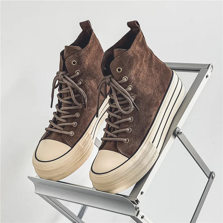 Close-up of men's platform trainers, showcasing the textured high-top design and durable sole.
