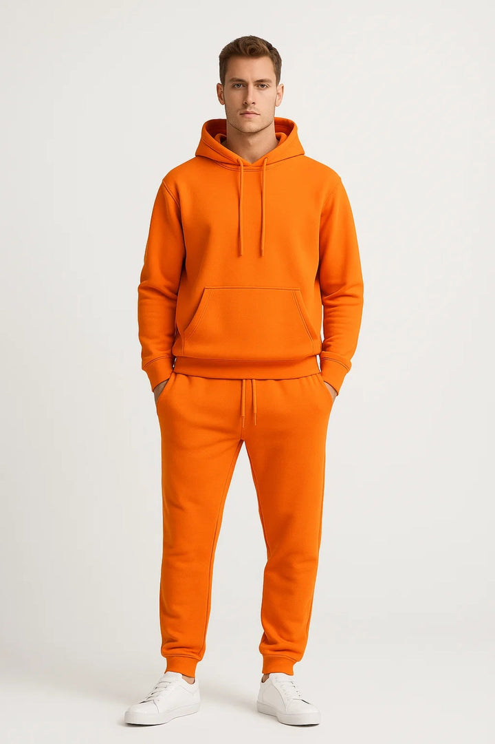 Model wearing a men's athleisure tracksuit with hoodie and joggers, showcasing a cozy loungewear outfit.