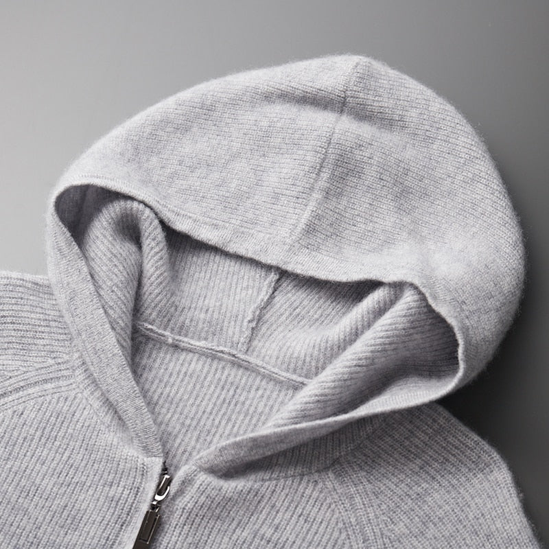 A man wearing a blue casual knitted hoodie, highlighting its streetwear style.