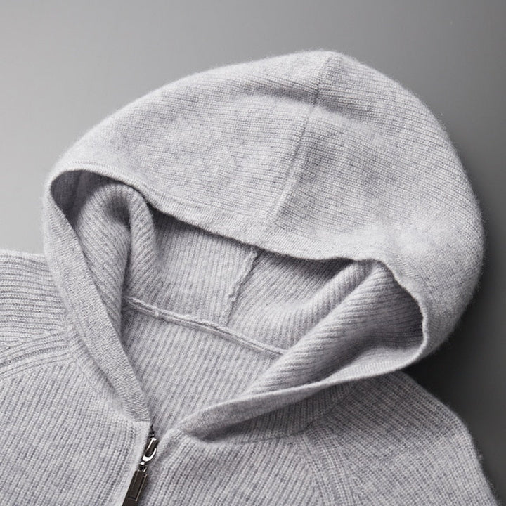 A man wearing a blue casual knitted hoodie, highlighting its streetwear style.
