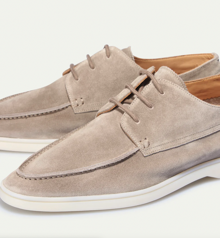 Close-up of men's casual lace-up boat shoes, showcasing design, stitching, and comfortable sole for everyday wear.