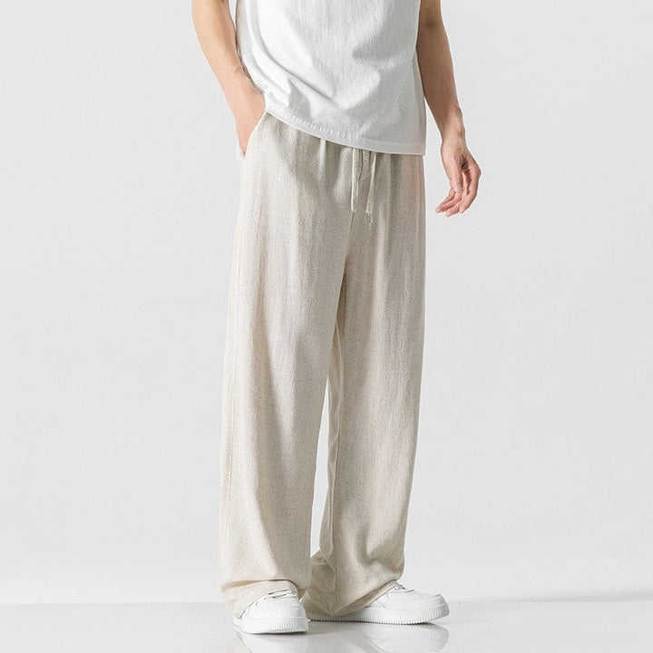 Men's casual loose-fit drawstring trousers in beige, ideal for comfortable everyday wear.