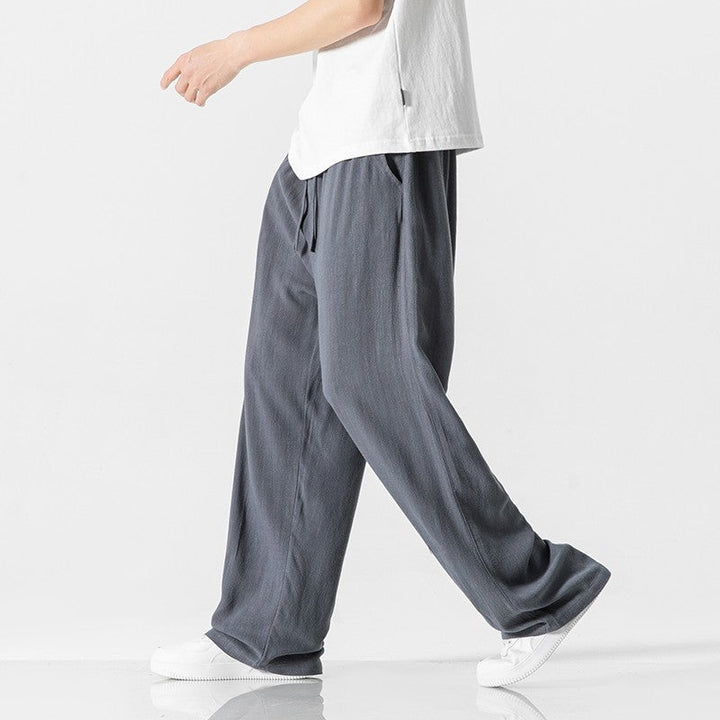Full-length men's relaxed-fit pants with an adjustable drawstring waist, perfect for casual fashion.