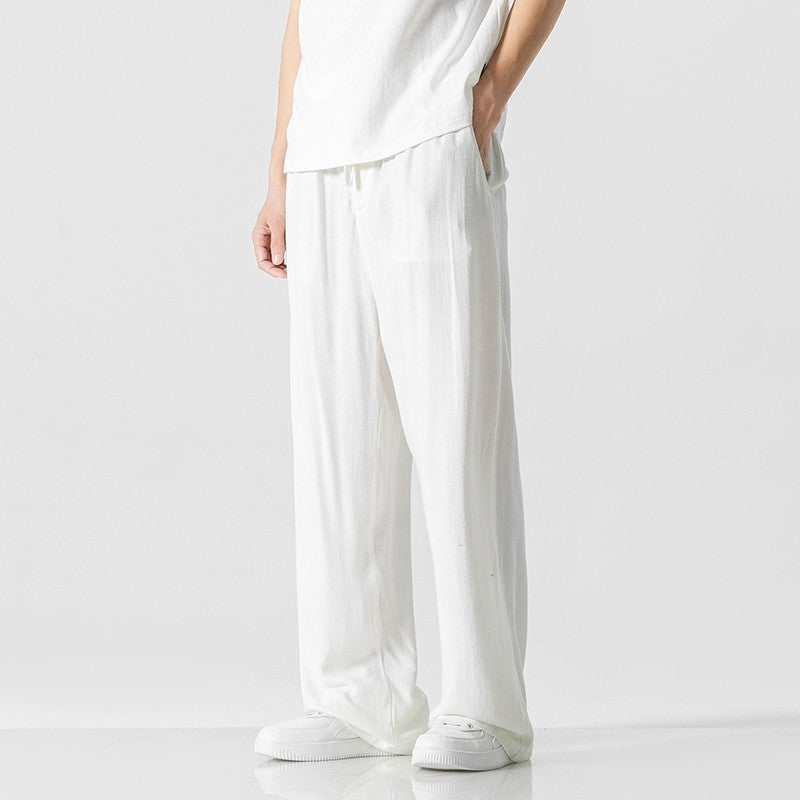 Versatile men's loose-fit trousers in a dark color, featuring a comfortable drawstring waist.