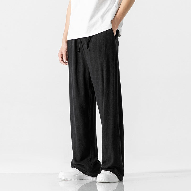Comfortable men's drawstring trousers, loose fit and full length, suitable for various casual occasions.