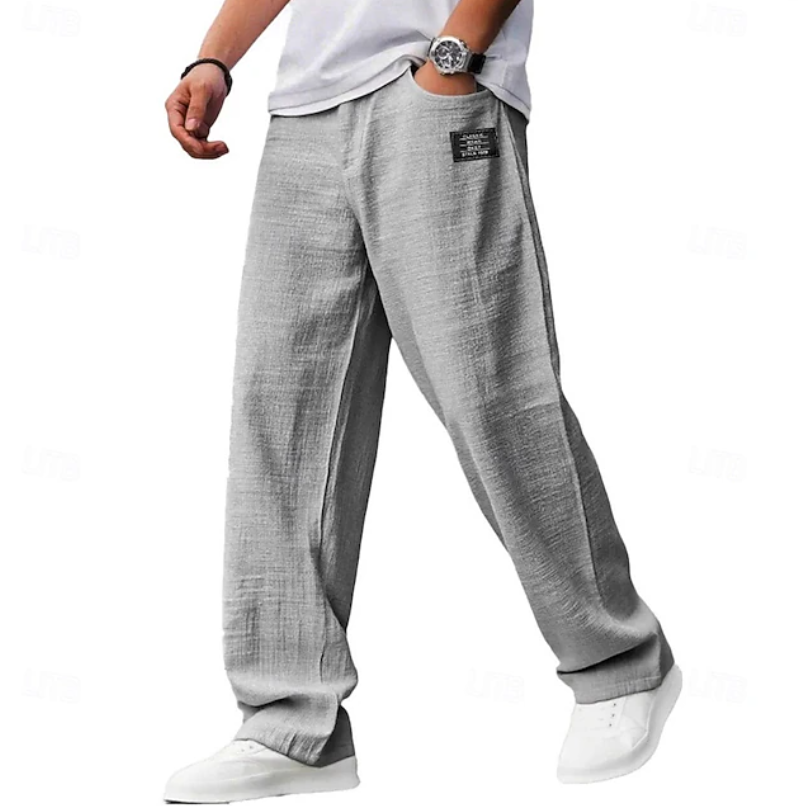 Man enjoying ultimate comfort in versatile men's casual loose everyday pants. Perfect for travel or lounge wear.