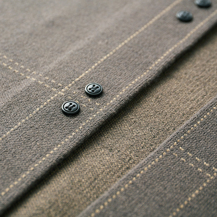 Classic plaid pattern on a men's button-front cardigan sweater, adding style to any outfit.