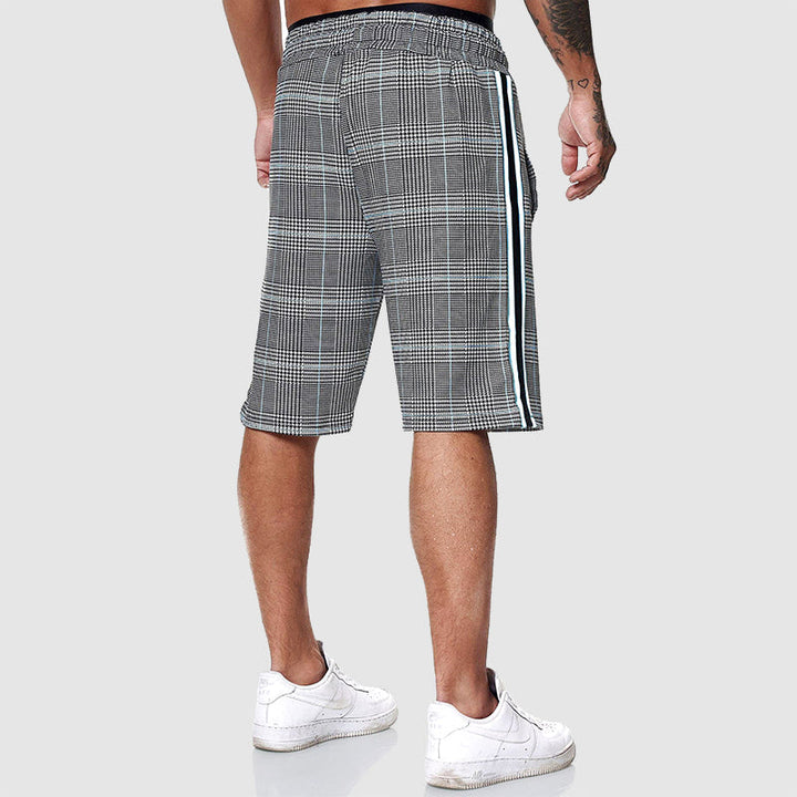 Men's relaxed fit plaid shorts with adjustable drawstring waist, designed for ultimate summer comfort.