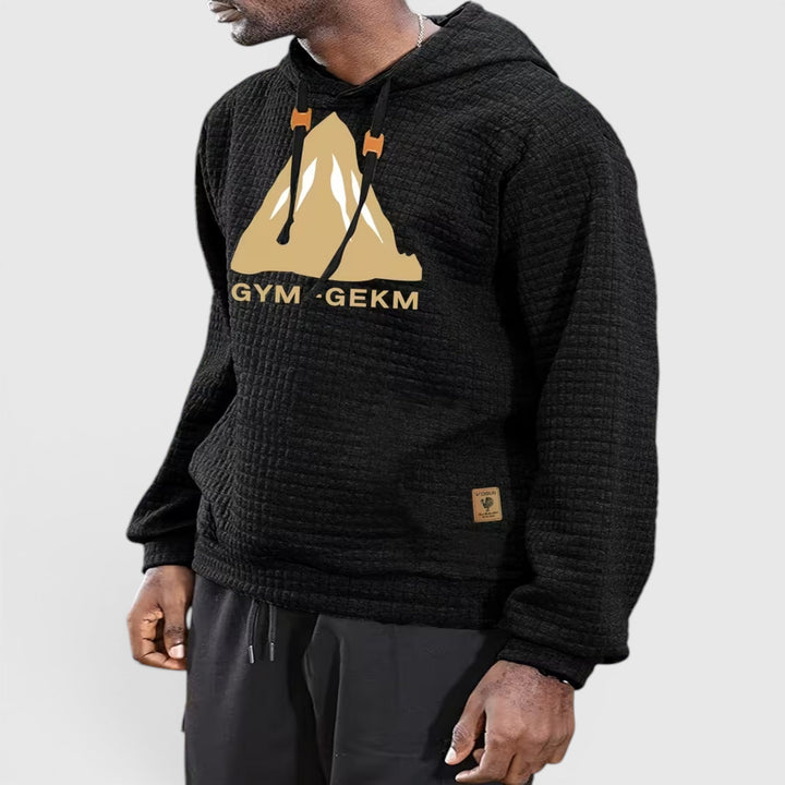 Black men's textured hoodie, comfortable casual pullover for fall evenings.