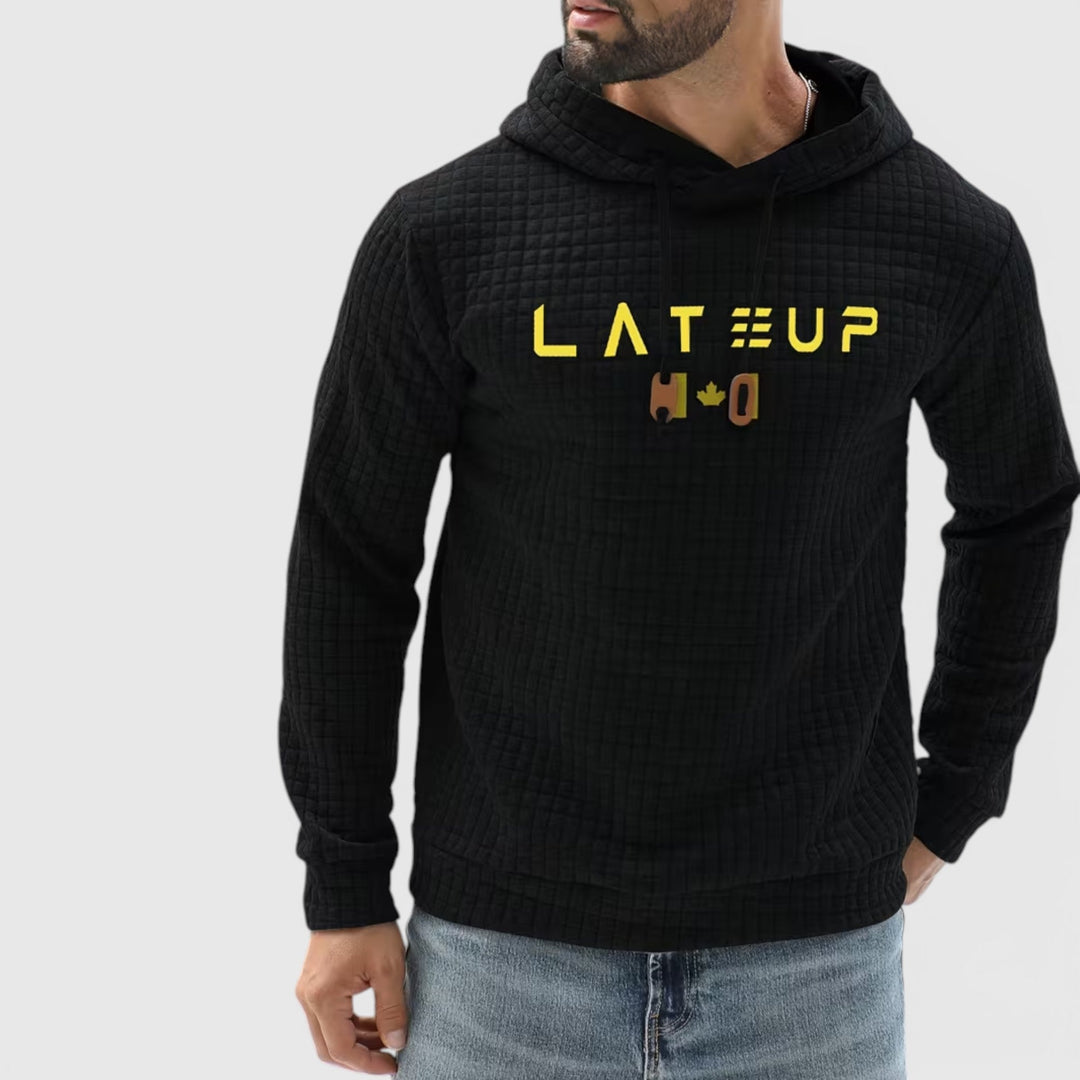 Black men's textured pullover hoodie, versatile casual wear for cold seasons.