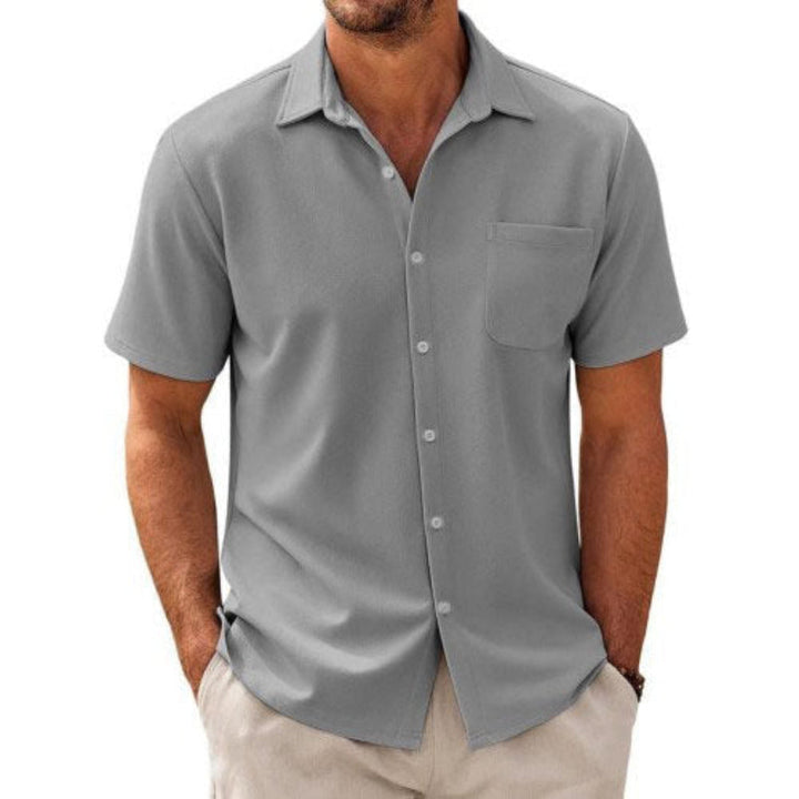 Men's casual short sleeve shirt with chest pocket in solid color.