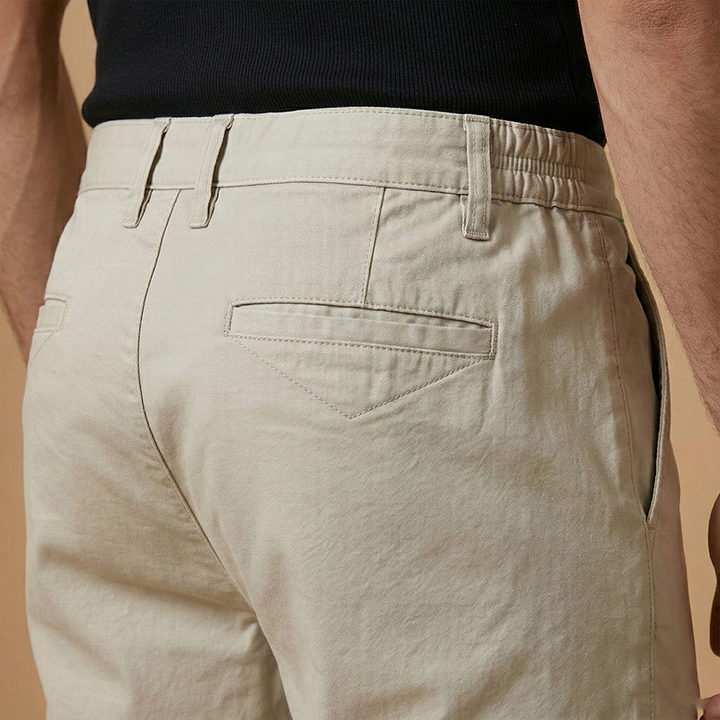 A man wearing casual structured fit shorts, perfect for warm weather activities.