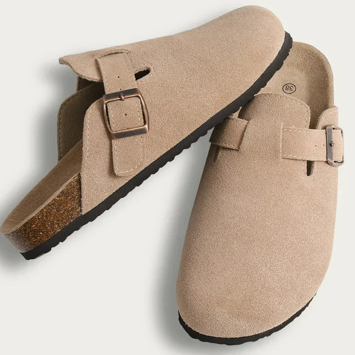 Men's clog slippers made from premium suede with a functional buckle strap closure.