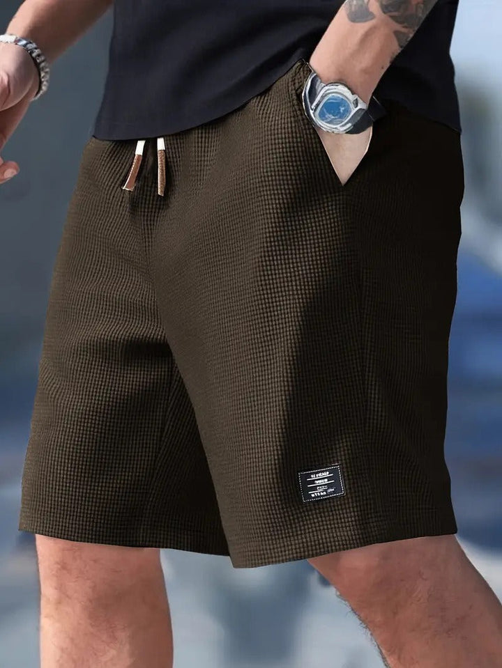 Men's stylish casual summer shorts paired with a light t-shirt, showcasing warm-weather vacation wear.