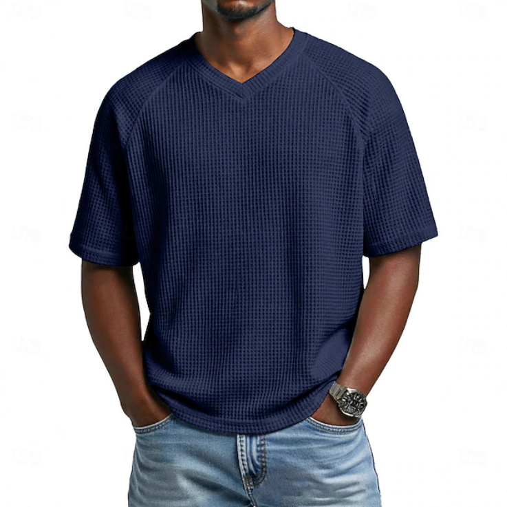 Close-up of men's textured V-neck short sleeve shirt fabric, highlighting casual style & comfort.