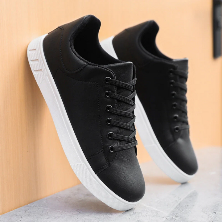 Close-up of men's casual lace-up sneakers, highlighting breathable material.