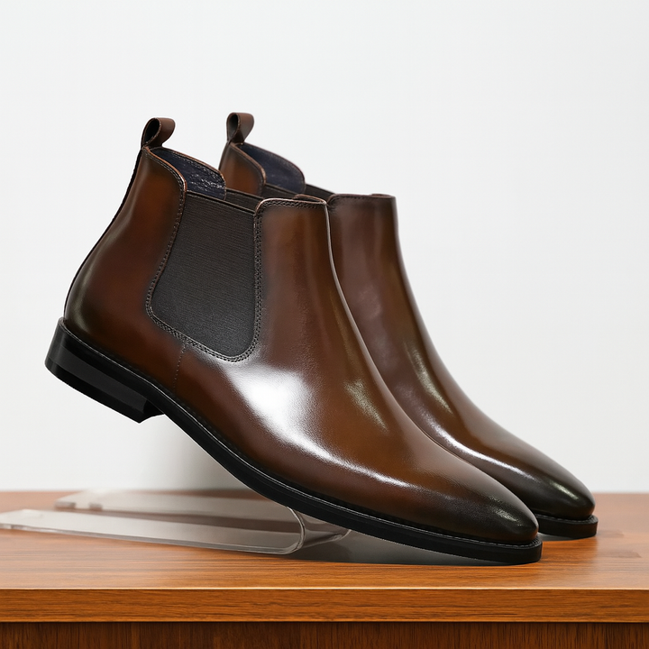 Men's classic black leather Chelsea boots, timeless slip-on ankle style for versatile dress or casual wear.