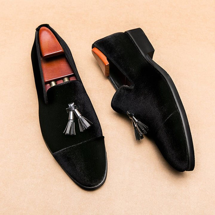 Men's sophisticated footwear: classic black tassel loafers. Slip-on elegant dress shoes for stylish men.