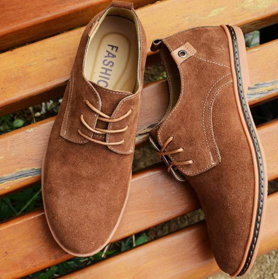 Close-up of a men's classic Oxford dress shoe, highlighting the refined lace-up details and sleek formal design.