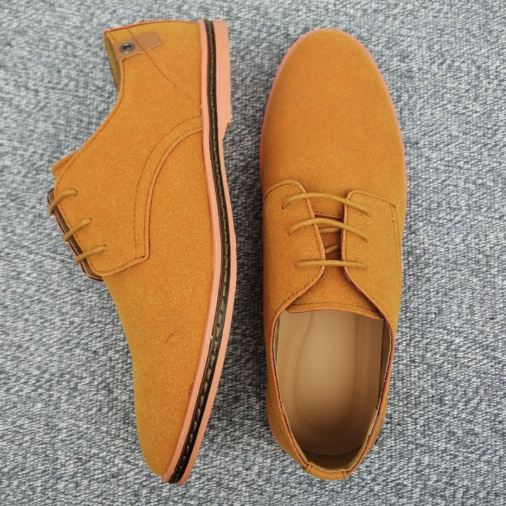 Close-up of men's elegant Oxford shoes, showing fine stitching & classic lace-up detail.