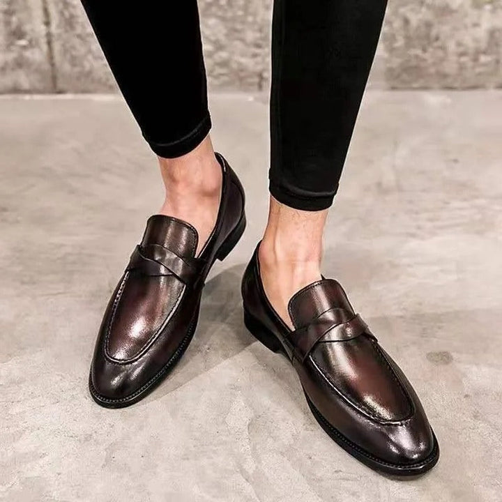 Men's classic black penny loafers. Stylish slip-on dress shoes for formal or smart casual wear.