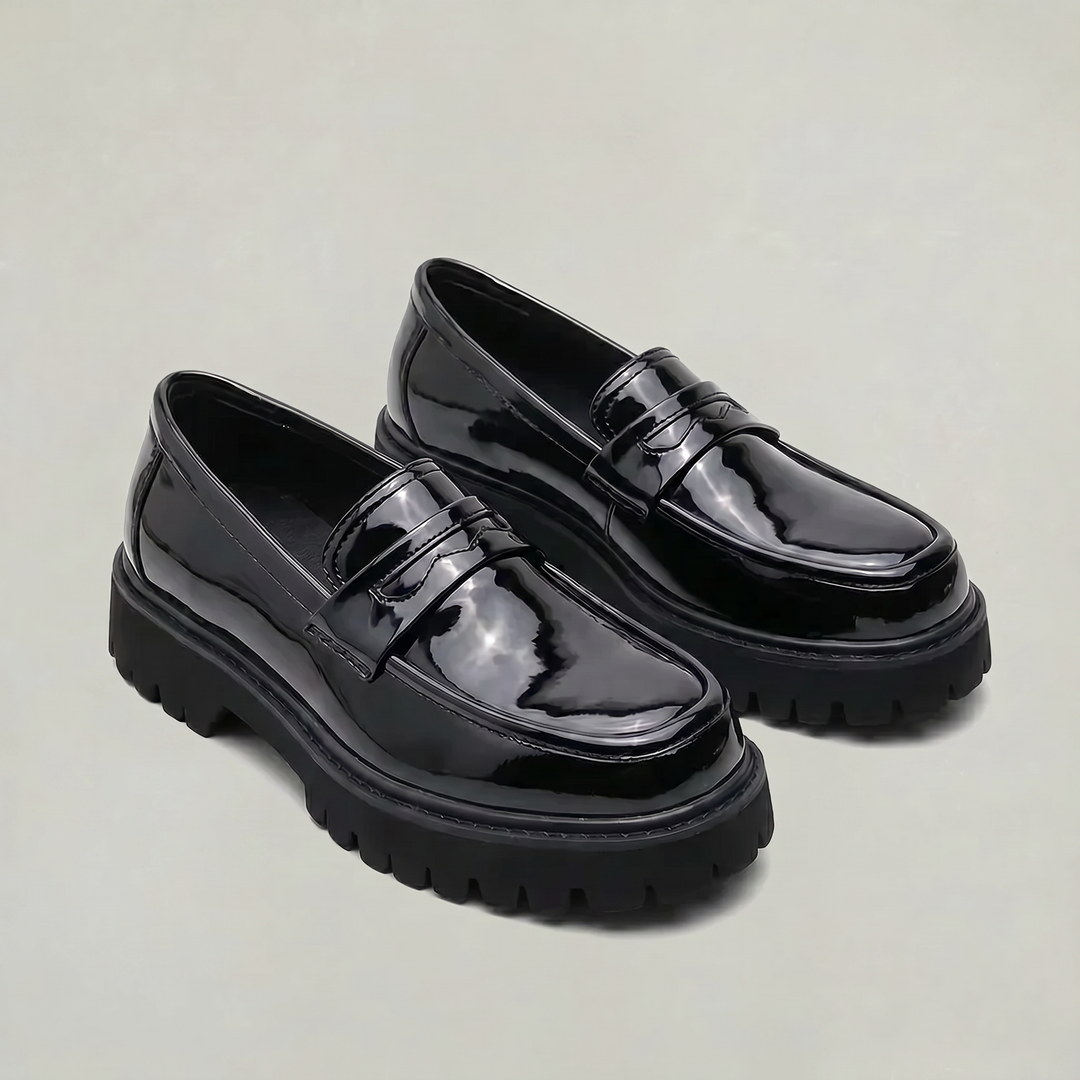 Polished men's slip-on penny loafers featuring a chunky platform sole for comfort and smart casual style.
