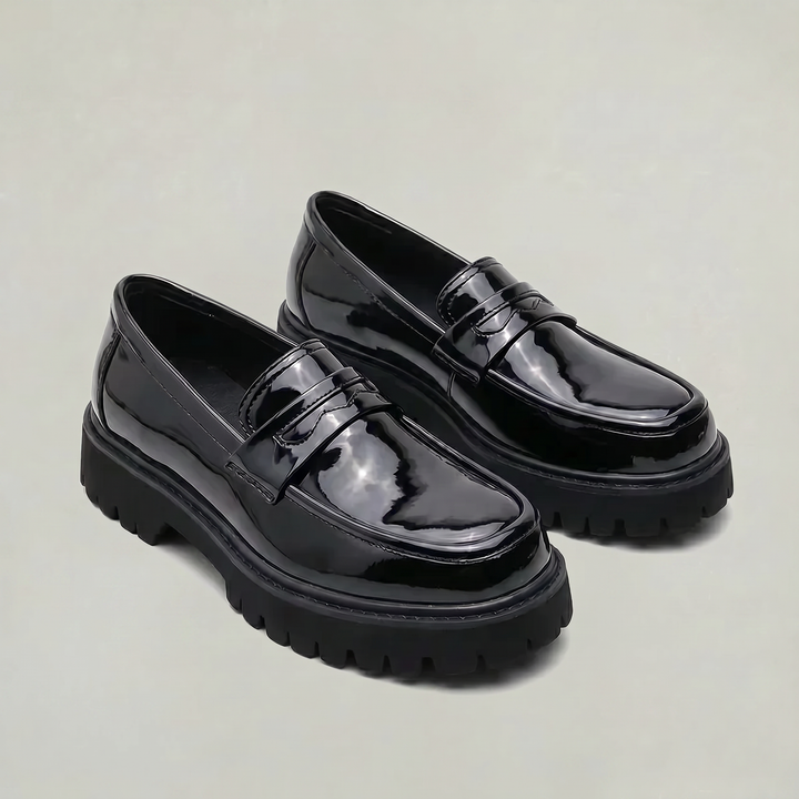 Polished men's slip-on penny loafers featuring a chunky platform sole for comfort and smart casual style.