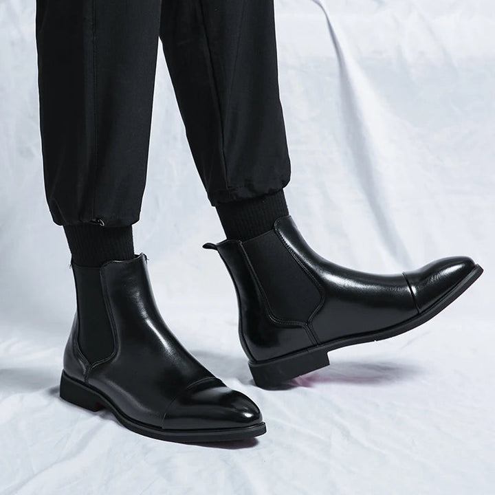 Stylish red men's Chelsea boots, easy slip-on ankle boots featuring a sophisticated cap toe. Versatile smart casual footwear.