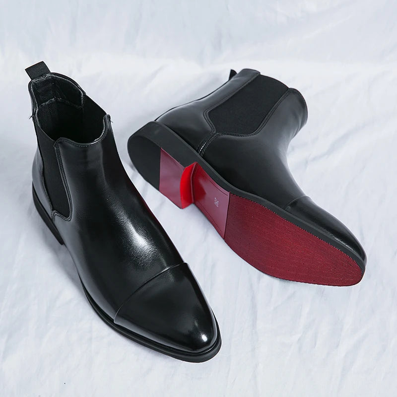 Black men's slip-on Chelsea ankle boots featuring a refined cap toe. Ideal dress boots for contemporary men's fashion.