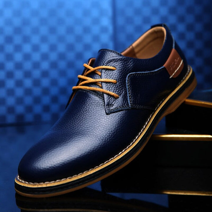 Men's classic blue leather Oxford dress shoes for formal and casual wear.