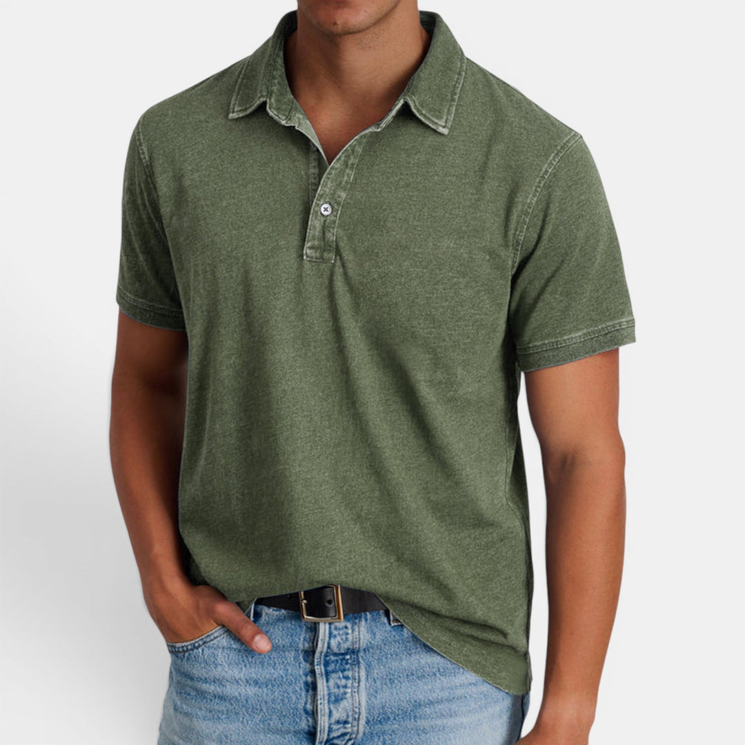 Close-up of a men's classic black polo shirt, short sleeve, button collar detail. Versatile fashion.