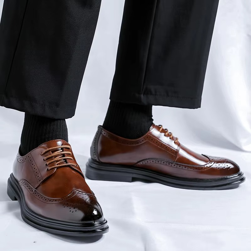 Classic men's lace-up wingtip brogue Derby shoes in leather, a staple for sophisticated business attire.