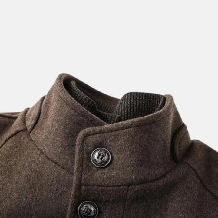 Modern men's gray mid-length overcoat, offering elevated style and comfort for cooler seasons.