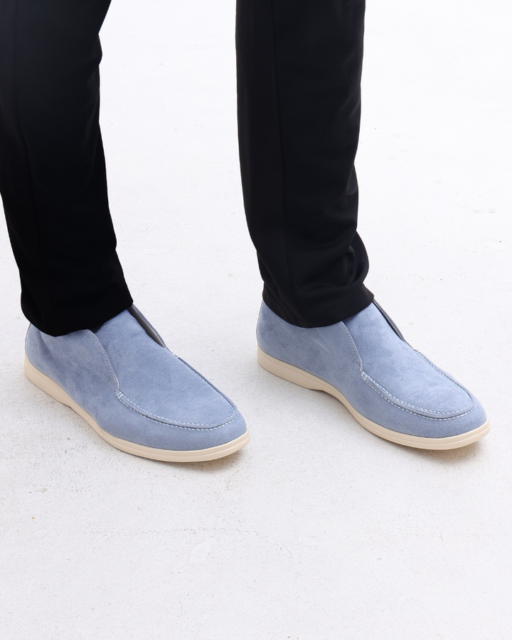 Full view of men's modern suede loafers, emphasizing their easy slip-on nature.