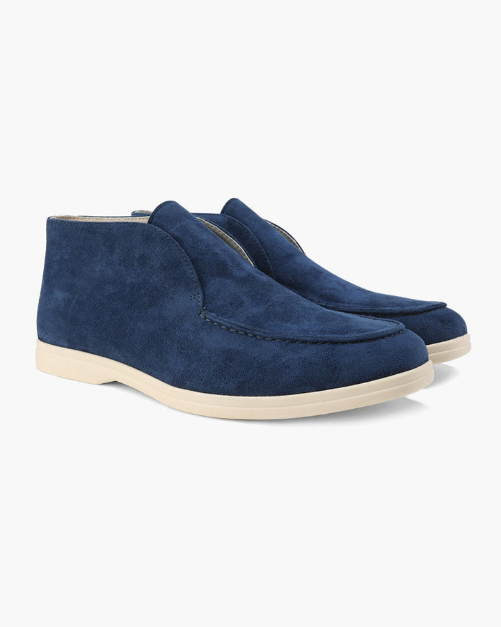 Close-up of men's soft suede slip-on loafers in a rich tan color.