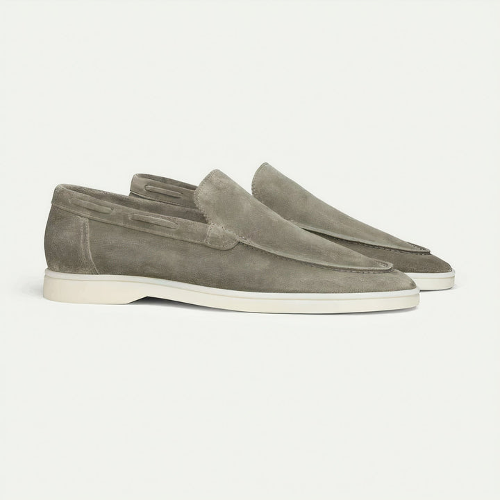 Close-up of men's tan suede loafers, showcasing stitching and classic style